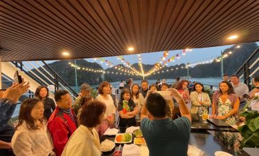 Enjoying a lively cruise party on Halong Bay with scenic views and happy travelers.