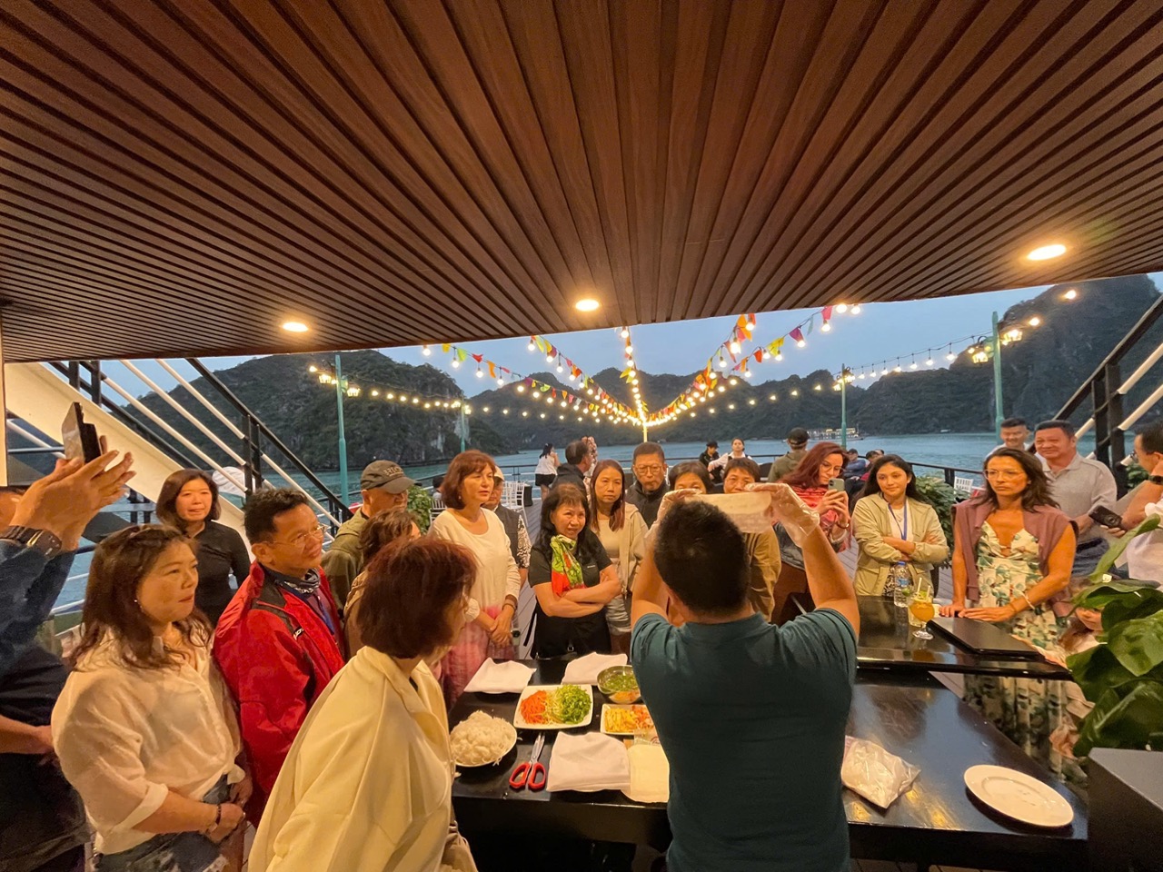 Enjoying a lively cruise party on Halong Bay with scenic views and happy travelers.