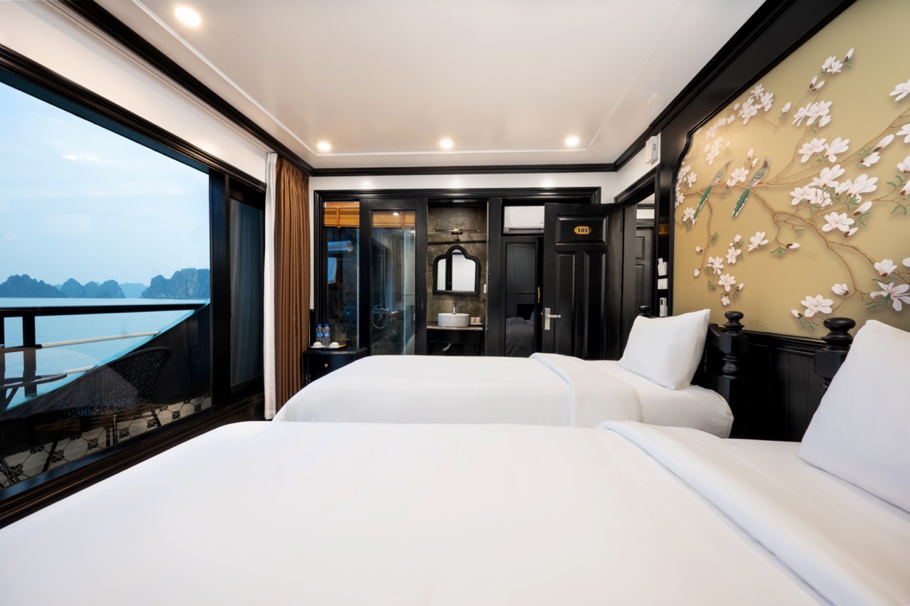 Elegant cruise cabin with panoramic bay views, perfect for relaxing during Halong Bay cruise.