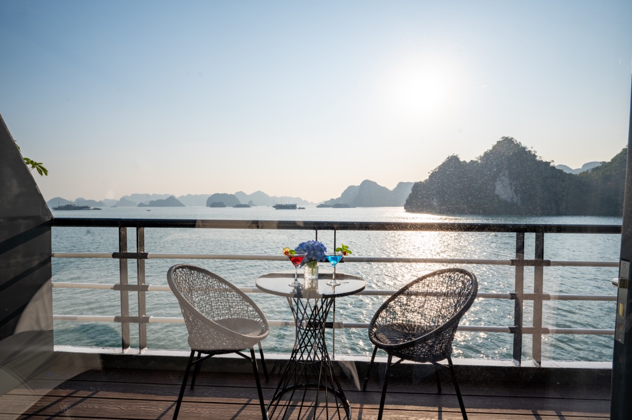 Beautiful Lan Ha Bay cruise balcony scene with ocean view, mountain islands, and tranquil atmosphere.