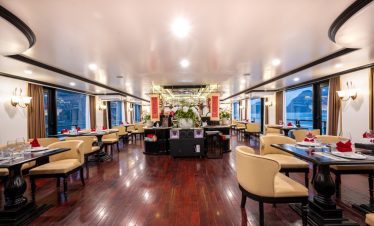 Luxurious cruise lounge with elegant decor and panoramic windows in Halong Bay.