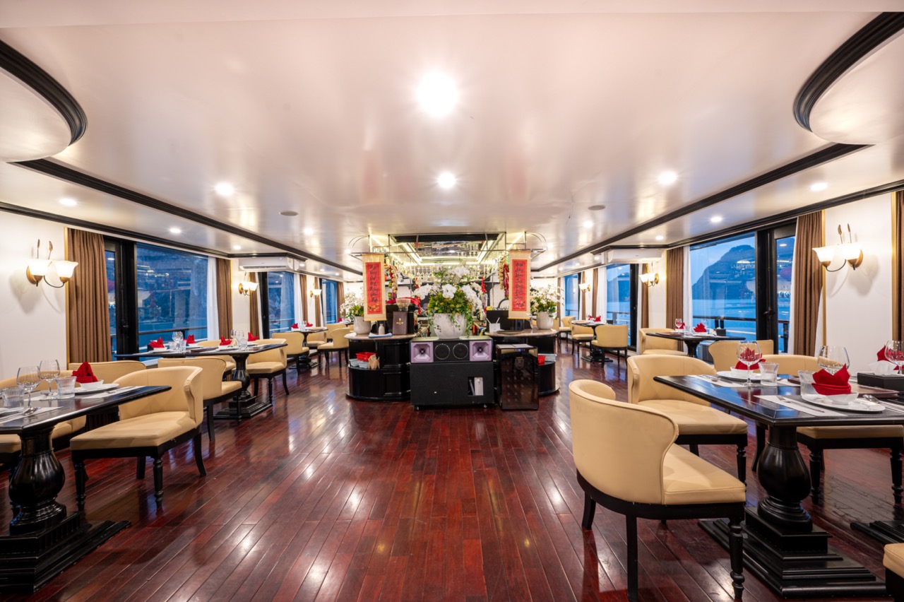 Luxurious cruise lounge with elegant decor and panoramic windows in Halong Bay.