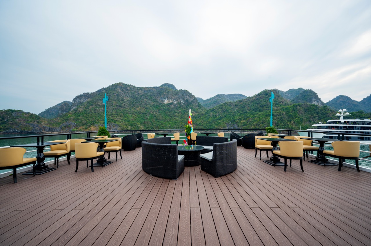 Spacious cruise balcony overlooking Lan Ha Bay with scenic mountain backdrop, ideal for leisure.