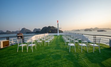 Beautiful Lan Ha Bay cruise balcony with seating and ocean scenery at sunset, perfect for relaxing a.