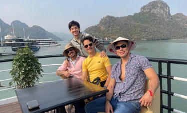 Enjoying Lan Ha Bay cruise balcony with stunning limestone karsts and calm waters, perfect for relax.