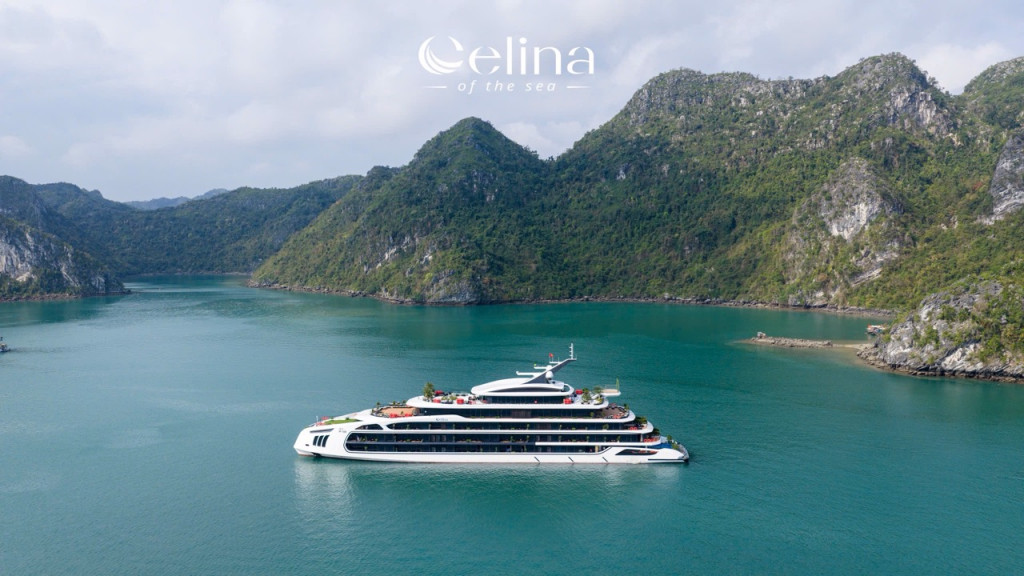 Luxurious white yacht cruising in a calm turquoise bay, surrounded by forested green cliffs, with the 'Elina of the Sea' logo above.