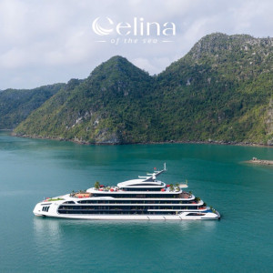 Luxurious white yacht cruising in a calm turquoise bay, surrounded by forested green cliffs, with the 'Elina of the Sea' logo above.