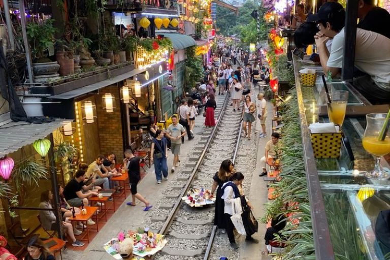 Vietnam street market bustling with vibrant lights and lively shoppers.